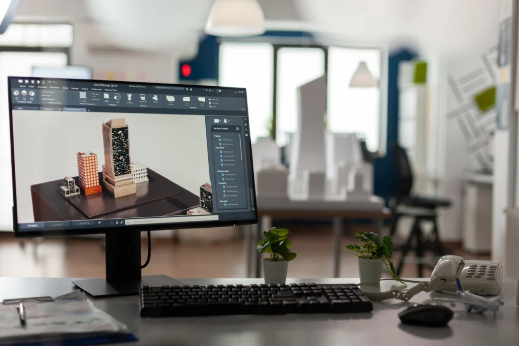 Pantalla de ordenador mostrando un diseño arquitectónico en 3D en un estudio de arquitectura